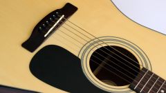 What distinguishes the classical guitar from the acoustic