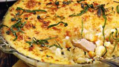 Potato casserole with chicken and cheese in the oven