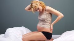 Почему у беременных болит спина
