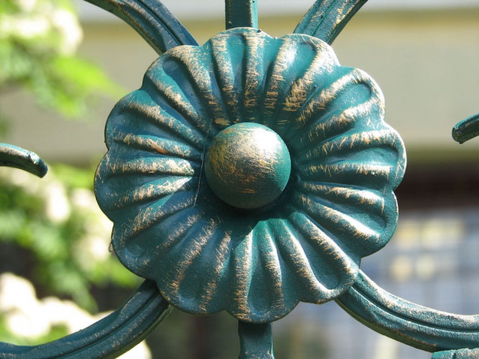 The patina on the decoration of the fence. Italy