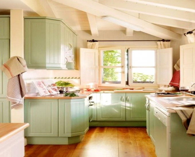 The kitchen is in the pistachio color