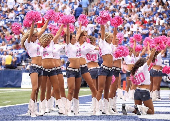 Girls cheerleaders performing with POM-poms.