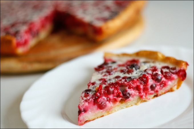 Open pie made of yeast dough with cranberries 