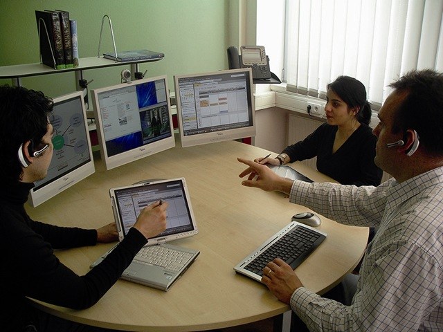 the people in the office at the computer table